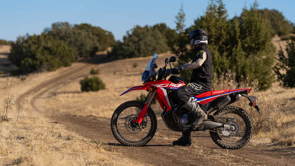 Honda CRF300 Rally on a Dirt Road with a Rider