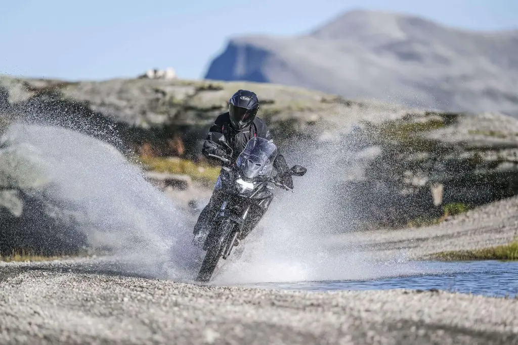 Honda CB500x being driven through a patch of water